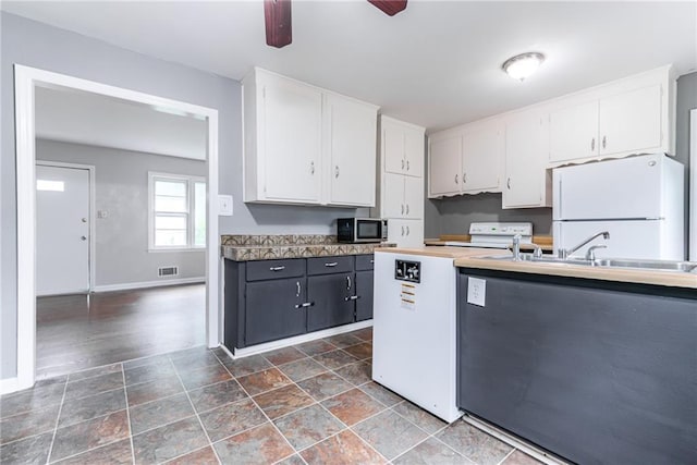 6721 Larsen Ln, Shawnee, KS 66203 - kitchen featuring white appliances, white cabinetry, baseboards, and a sink