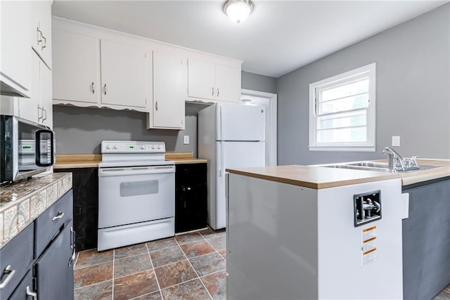 6721 Larsen Ln, Shawnee, KS 66203 - kitchen with white appliances, white cabinetry, light countertops, and dark stone finish floors
