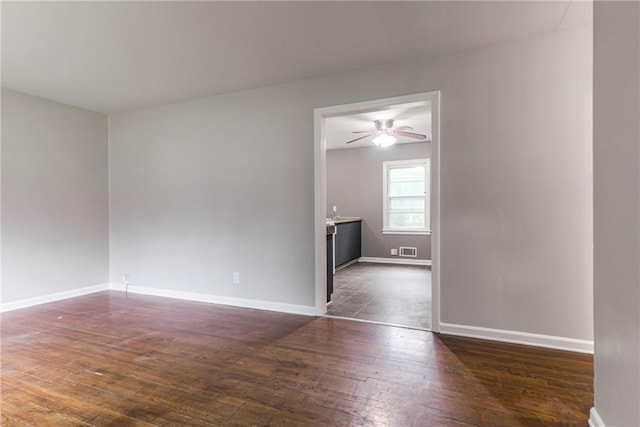 6721 Larsen Ln, Shawnee, KS 66203 - empty room featuring dark wood-style flooring, baseboards, and ceiling fan