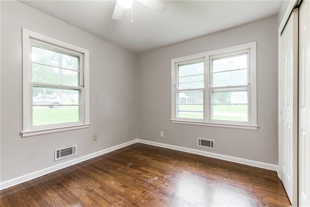 6721 Larsen Ln, Shawnee, KS 66203 - unfurnished bedroom with baseboards, dark wood-style floors, a closet, and a ceiling fan