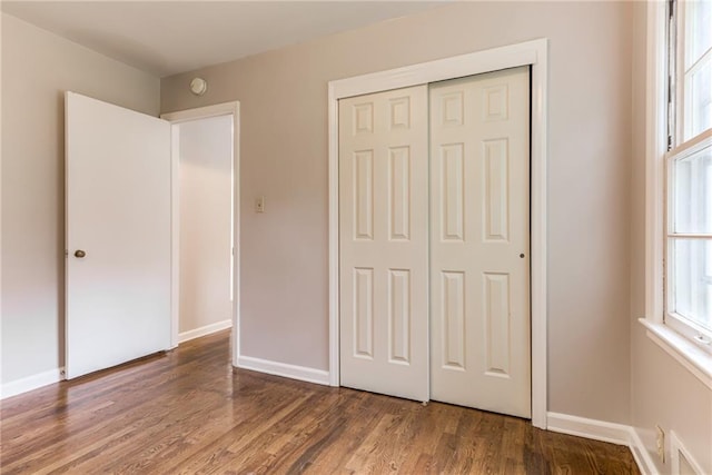 6721 Larsen Ln, Shawnee, KS 66203 - unfurnished bedroom featuring wood finished floors, a closet, and baseboards