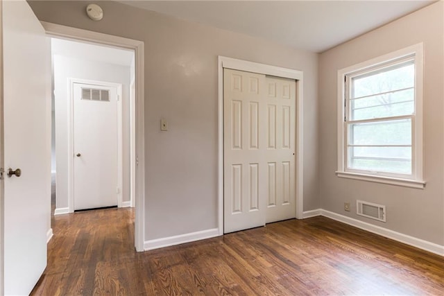 6721 Larsen Ln, Shawnee, KS 66203 - unfurnished bedroom with wood finished floors, baseboards, and a closet