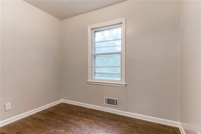6721 Larsen Ln, Shawnee, KS 66203 - spare room featuring baseboards, dark wood-style floors, and plenty of natural light