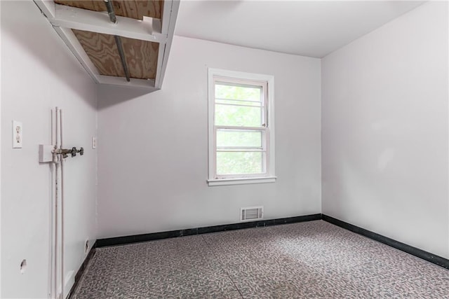 6721 Larsen Ln, Shawnee, KS 66203 - unfurnished room with baseboards and attic access