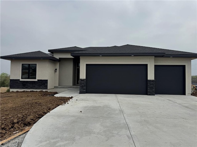 9019 Freedom Cir, Lenexa, KS 66227 - prairie-style home with an attached garage, driveway, stucco siding, and stone siding