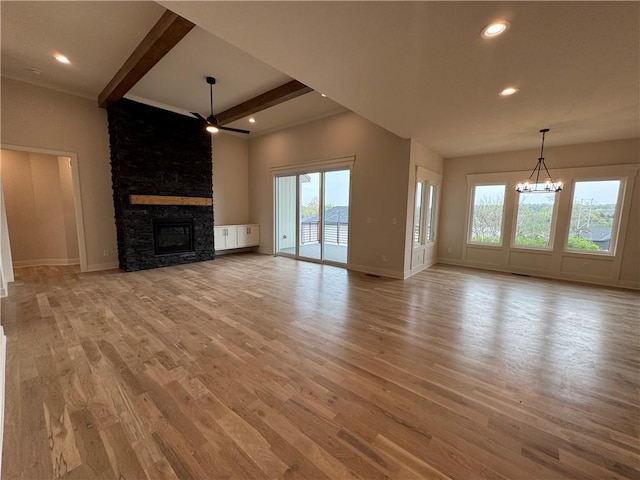 9019 Freedom Cir, Lenexa, KS 66227 - unfurnished living room with a chandelier, beamed ceiling, light wood finished floors, a fireplace, and recessed lighting