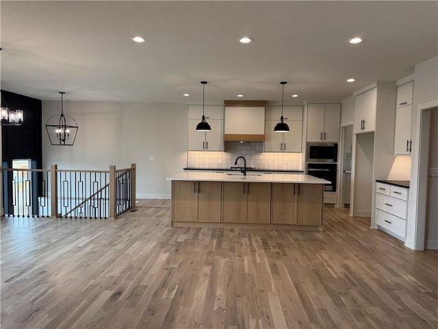 9019 Freedom Cir, Lenexa, KS 66227 - kitchen featuring wall oven, a chandelier, tasteful backsplash, light wood finished floors, and recessed lighting