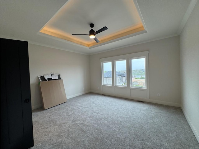 9019 Freedom Cir, Lenexa, KS 66227 - unfurnished room featuring a tray ceiling, carpet flooring, a ceiling fan, baseboards, and ornamental molding