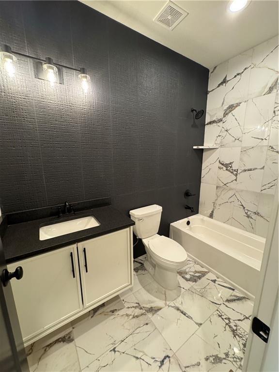 9019 Freedom Cir, Lenexa, KS 66227 - bathroom featuring marble finish flooring, washtub / shower combination, toilet, vanity, and recessed lighting