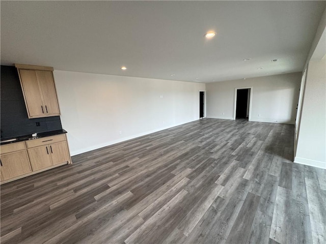 9019 Freedom Cir, Lenexa, KS 66227 - unfurnished living room featuring dark wood finished floors, baseboards, and recessed lighting