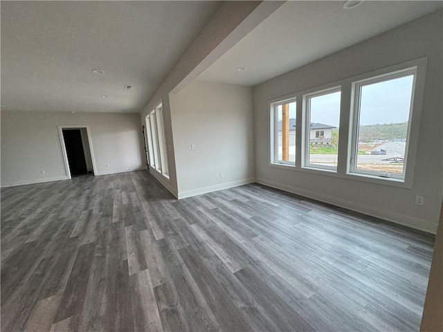 9019 Freedom Cir, Lenexa, KS 66227 - unfurnished living room featuring dark wood-style floors and baseboards