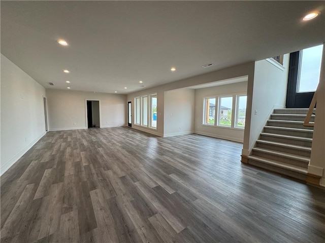 9019 Freedom Cir, Lenexa, KS 66227 - unfurnished living room featuring dark wood-style floors, stairs, baseboards, and recessed lighting