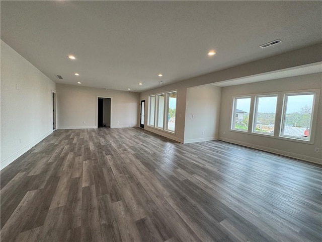 9019 Freedom Cir, Lenexa, KS 66227 - unfurnished living room with dark wood-style flooring, recessed lighting, healthy amount of natural light, and baseboards