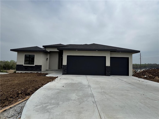 9019 Freedom Cir, Lenexa, KS 66227 - prairie-style home featuring an attached garage, concrete driveway, stucco siding, and stone siding