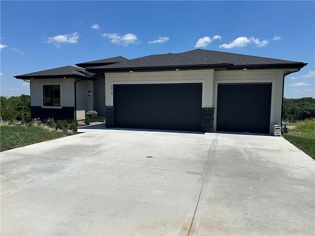 9019 Freedom Cir, Lenexa, KS 66227 - prairie-style house with an attached garage, driveway, stone siding, and stucco siding