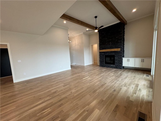 9019 Freedom Cir, Lenexa, KS 66227 - unfurnished living room with a fireplace, a ceiling fan, light wood-style floors, beamed ceiling, and recessed lighting