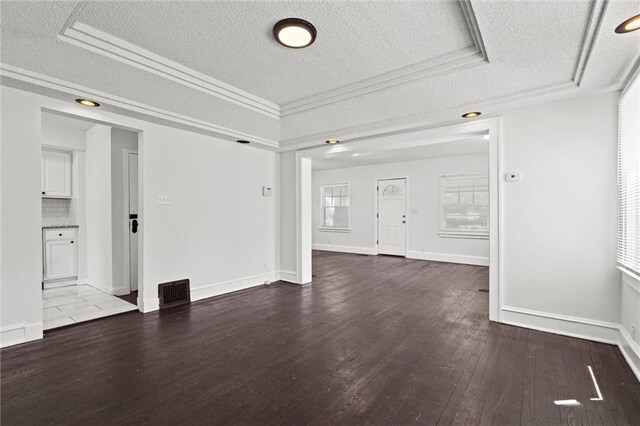 3218 Benton Blvd, Kansas City, MO 64128 - unfurnished living room featuring a textured ceiling, wood finished floors, and baseboards