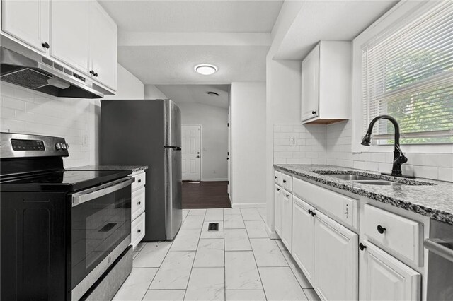 3218 Benton Blvd, Kansas City, MO 64128 - kitchen with appliances with stainless steel finishes, under cabinet range hood, a sink, light marble finish flooring, and white cabinetry