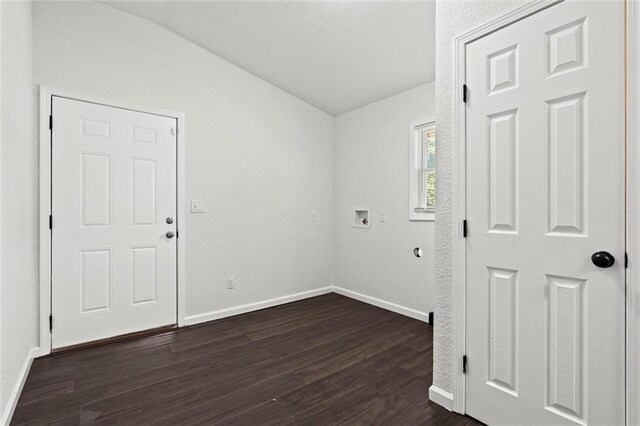 3218 Benton Blvd, Kansas City, MO 64128 - spare room featuring lofted ceiling, dark wood-style flooring, and baseboards