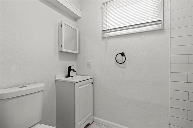 3218 Benton Blvd, Kansas City, MO 64128 - bathroom featuring toilet and vanity