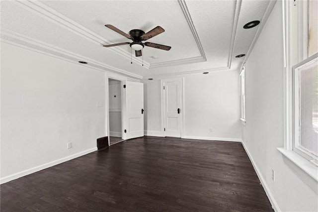 3218 Benton Blvd, Kansas City, MO 64128 - spare room with a raised ceiling, a ceiling fan, dark wood-style floors, a textured ceiling, and baseboards