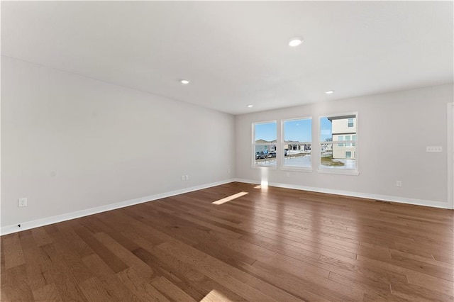 338 Meadowlark Dr, Raymore, MO 64083 - spare room featuring wood finished floors, baseboards, and recessed lighting