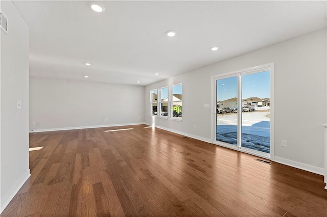 338 Meadowlark Dr, Raymore, MO 64083 - empty room featuring wood finished floors, baseboards, and recessed lighting