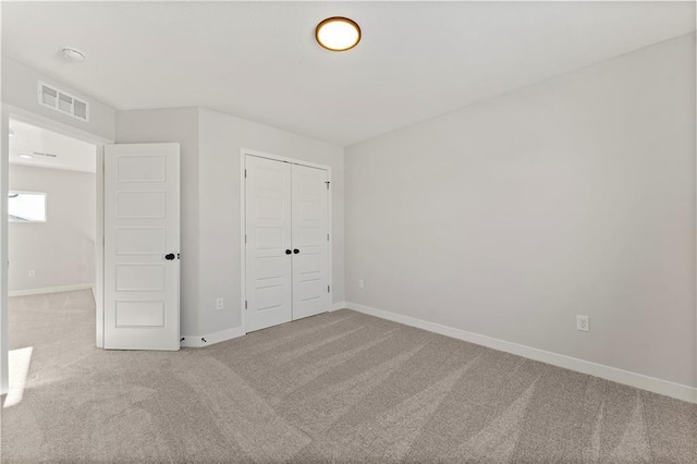 338 Meadowlark Dr, Raymore, MO 64083 - unfurnished bedroom featuring carpet floors, baseboards, and a closet