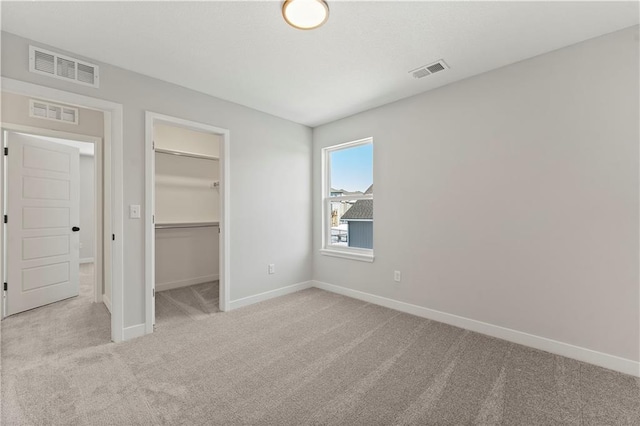 338 Meadowlark Dr, Raymore, MO 64083 - unfurnished bedroom with carpet flooring, baseboards, a spacious closet, and a closet