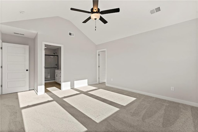 338 Meadowlark Dr, Raymore, MO 64083 - unfurnished bedroom with light colored carpet, vaulted ceiling, baseboards, and ensuite bathroom