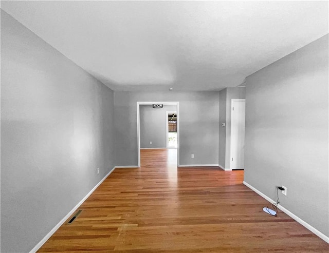 11709 Fremont Ave, Kansas City, MO 64134 - empty room with light wood finished floors and baseboards
