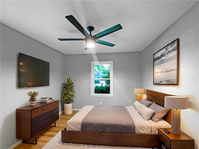 11709 Fremont Ave, Kansas City, MO 64134 - bedroom with light wood-style flooring, ceiling fan, and baseboards
