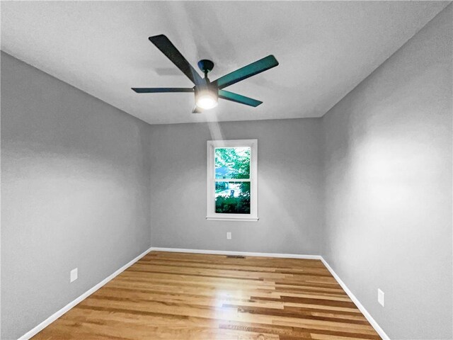 11709 Fremont Ave, Kansas City, MO 64134 - spare room featuring ceiling fan, wood finished floors, and baseboards