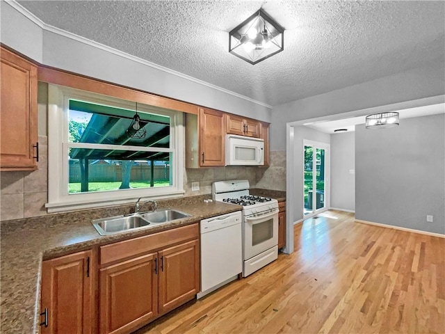 11709 Fremont Ave, Kansas City, MO 64134 - kitchen with white appliances, a sink, a textured ceiling, decorative backsplash, and light wood-type flooring