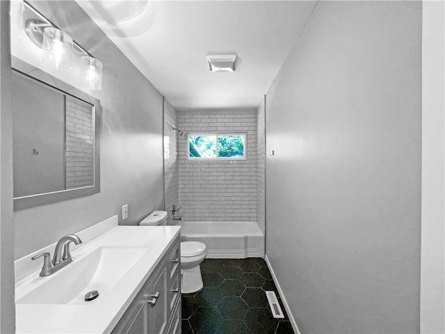 11709 Fremont Ave, Kansas City, MO 64134 - bathroom featuring toilet, vanity, tile patterned floors, baseboards, and shower / washtub combination