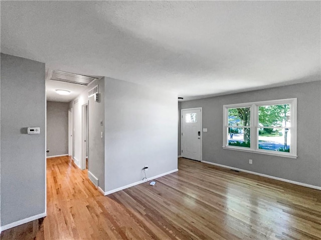 11709 Fremont Ave, Kansas City, MO 64134 - empty room featuring wood finished floors, baseboards, and a textured ceiling