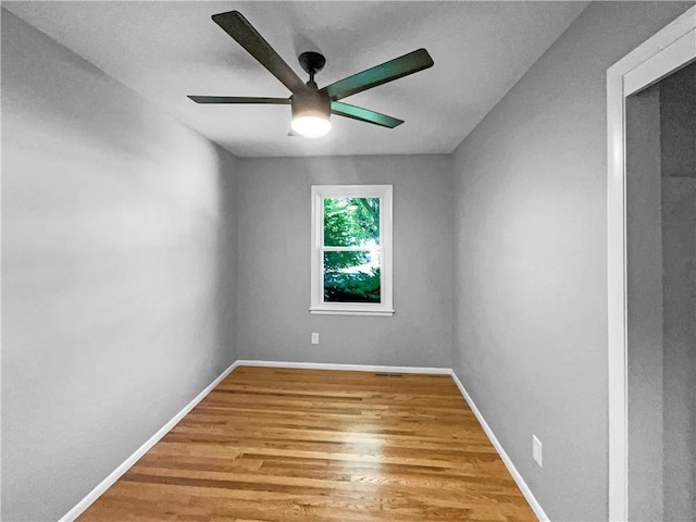 11709 Fremont Ave, Kansas City, MO 64134 - spare room featuring ceiling fan, wood finished floors, and baseboards