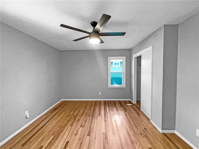 11709 Fremont Ave, Kansas City, MO 64134 - empty room with light wood-type flooring, a ceiling fan, and baseboards