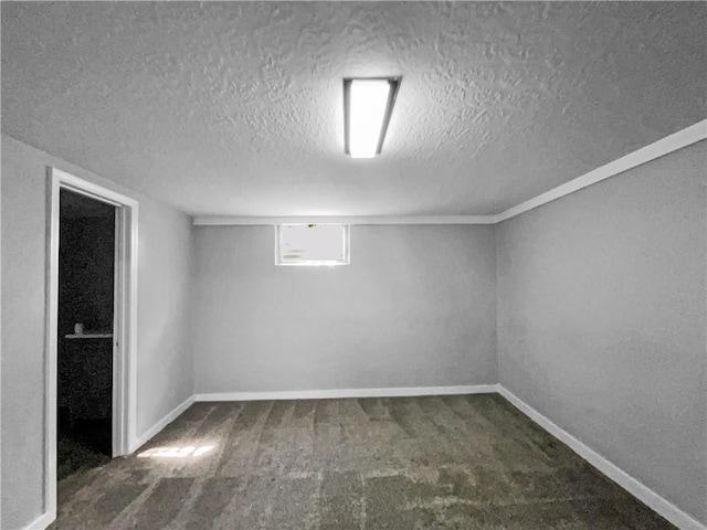 11709 Fremont Ave, Kansas City, MO 64134 - basement featuring a textured ceiling, carpet flooring, and baseboards