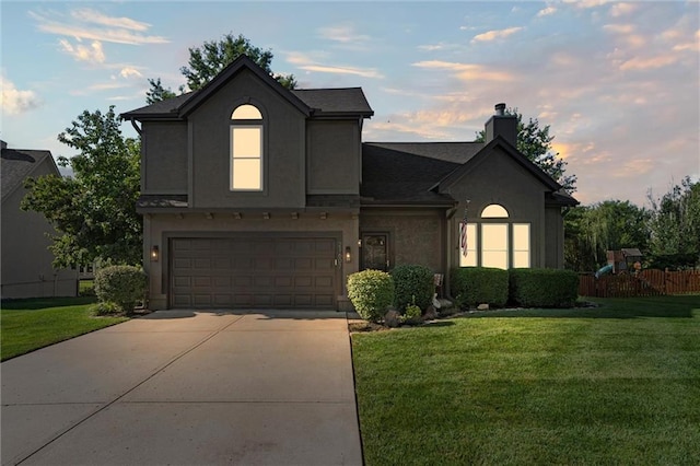 21607 W 51st St, Shawnee, KS 66226 - traditional-style home featuring a garage, a chimney, driveway, and stucco siding