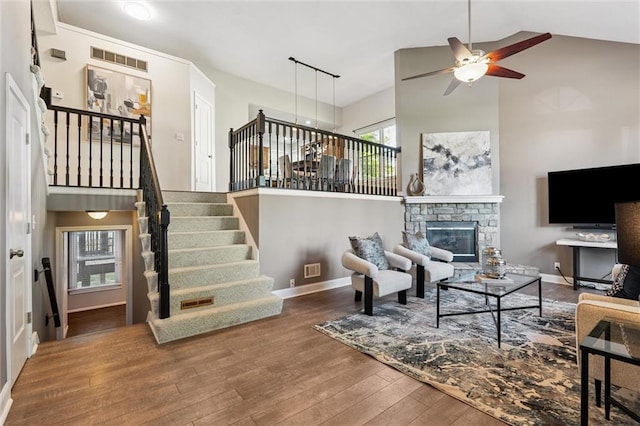 21607 W 51st St, Shawnee, KS 66226 - living room with high vaulted ceiling, ceiling fan, wood finished floors, stairs, and a stone fireplace