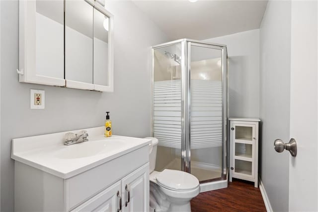 21607 W 51st St, Shawnee, KS 66226 - bathroom featuring a stall shower, vanity, and wood finished floors