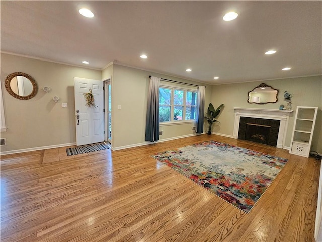 11306 E 45th St, Kansas City, MO 64133 - living area with crown molding, recessed lighting, wood finished floors, baseboards, and a tiled fireplace