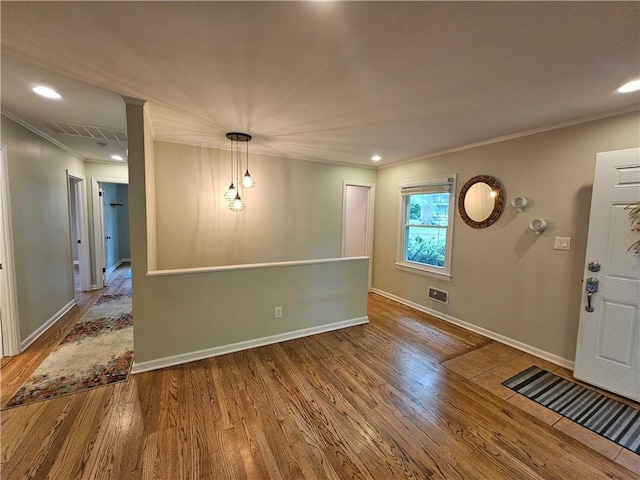 11306 E 45th St, Kansas City, MO 64133 - spare room with wood finished floors, ornamental molding, baseboards, and recessed lighting