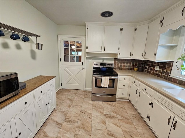 11306 E 45th St, Kansas City, MO 64133 - kitchen featuring appliances with stainless steel finishes, open shelves, white cabinets, tasteful backsplash, and light countertops