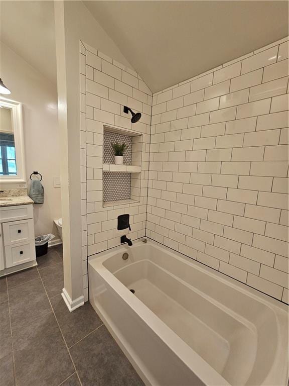 11306 E 45th St, Kansas City, MO 64133 - full bath featuring tile patterned flooring, vanity, vaulted ceiling, toilet, and shower / bathtub combination