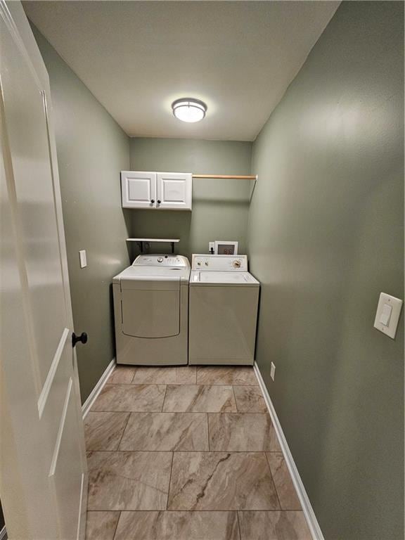 11306 E 45th St, Kansas City, MO 64133 - washroom with cabinet space, separate washer and dryer, and baseboards