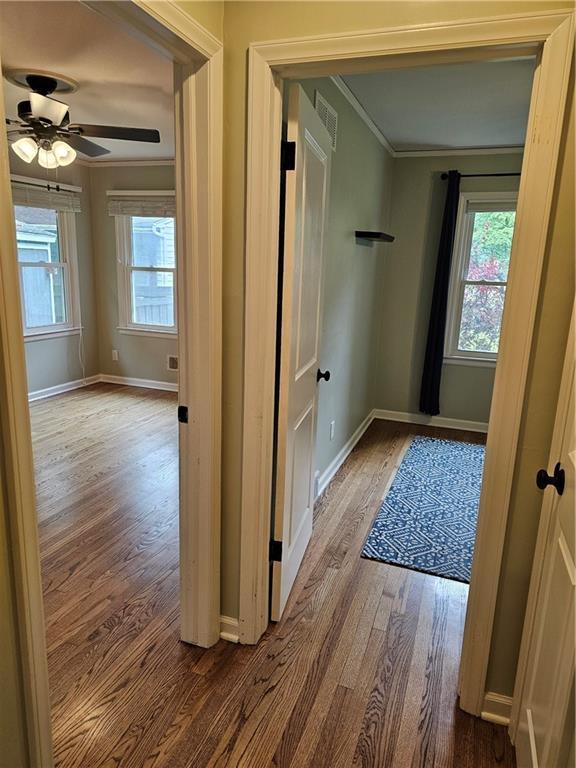 11306 E 45th St, Kansas City, MO 64133 - hall featuring wood finished floors, crown molding, and baseboards
