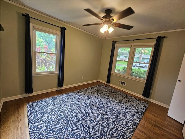 11306 E 45th St, Kansas City, MO 64133 - spare room with wood finished floors, healthy amount of natural light, ornamental molding, and ceiling fan