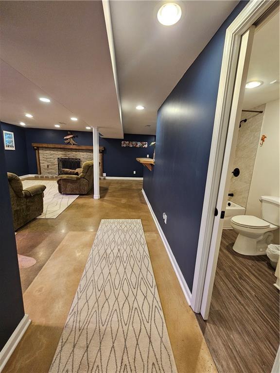 11306 E 45th St, Kansas City, MO 64133 - corridor featuring wood finished floors and baseboards